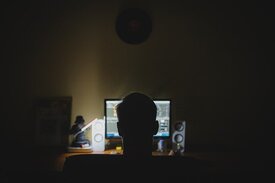 Man working on his computer at night